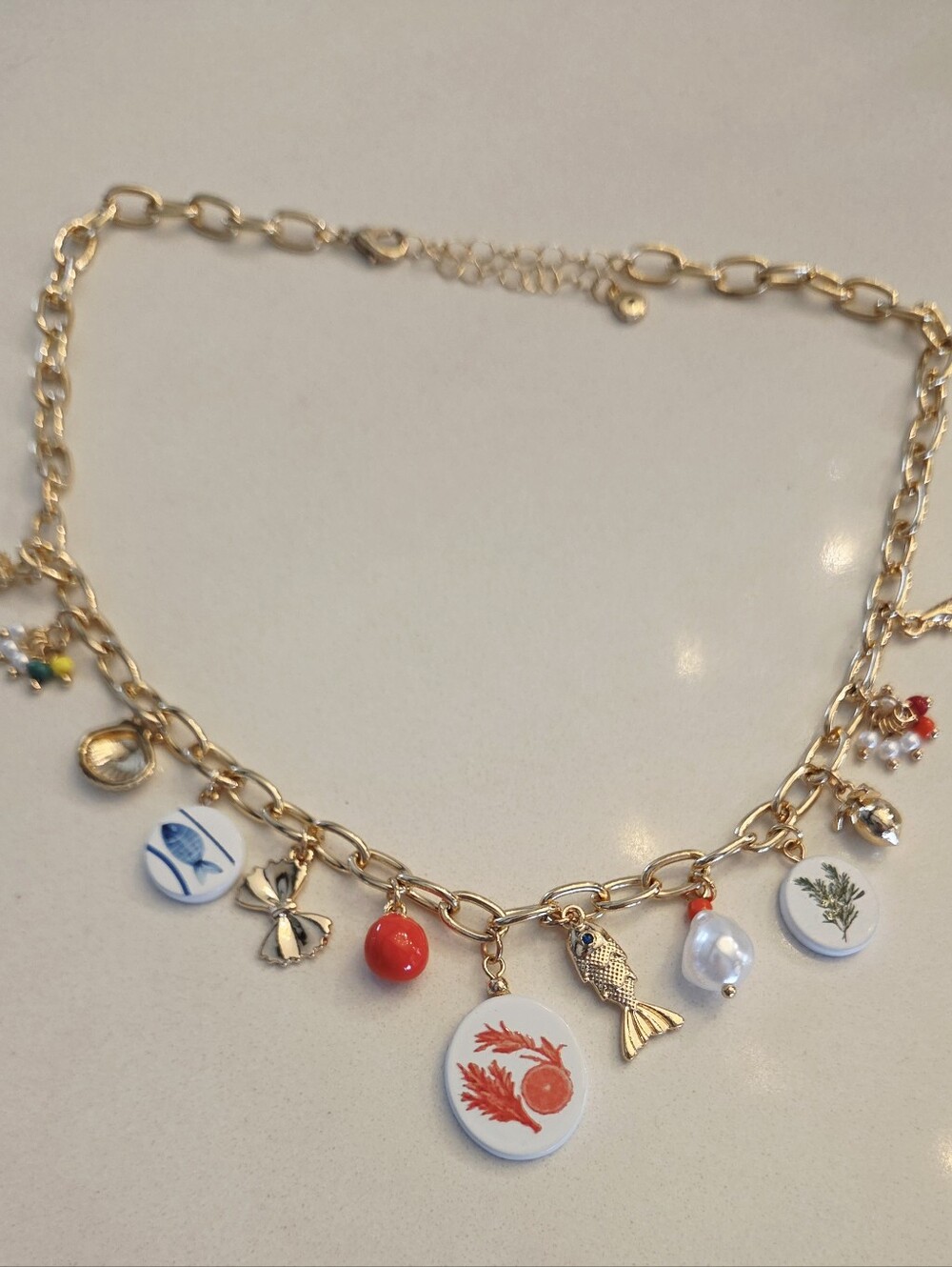 Gold-Tone Multi Charm Necklace with Coral & Pearl Accents
